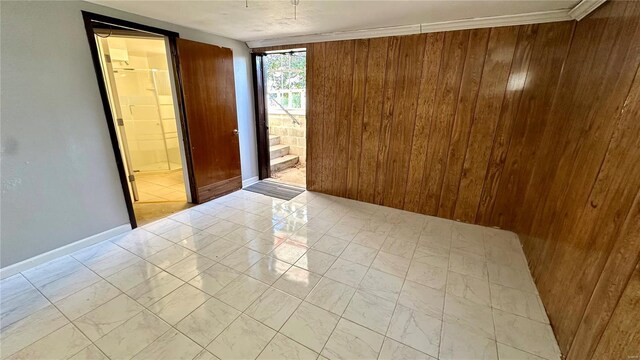 4400 Mohegan Dr, Saint Louis, MO 63123 - unfurnished room with wood walls, light marble finish flooring, and baseboards