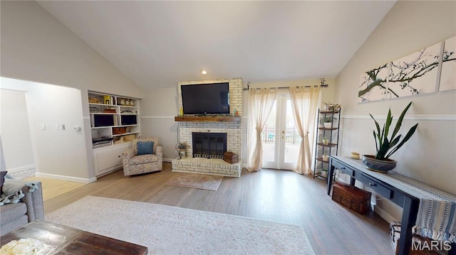 705 Linder Blvd, Greenville, IL 62246 - living room with a brick fireplace, wood finished floors, baseboards, and high vaulted ceiling