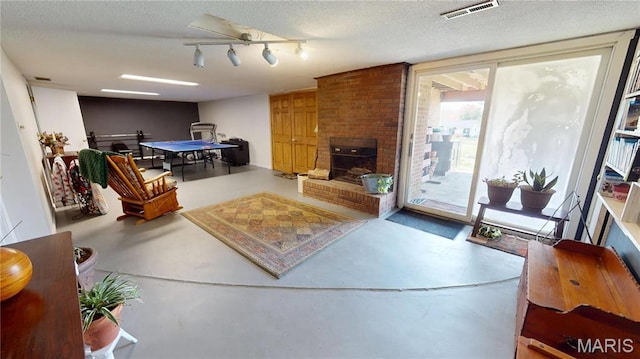 705 Linder Blvd, Greenville, IL 62246 - living area featuring concrete floors, a fireplace, and a textured ceiling
