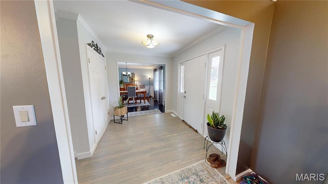 705 Linder Blvd, Greenville, IL 62246 - foyer with crown molding, light wood-style flooring, and baseboards