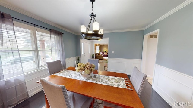 705 Linder Blvd, Greenville, IL 62246 - dining area featuring a chandelier, ornamental molding, a wainscoted wall, dark wood finished floors, and a decorative wall