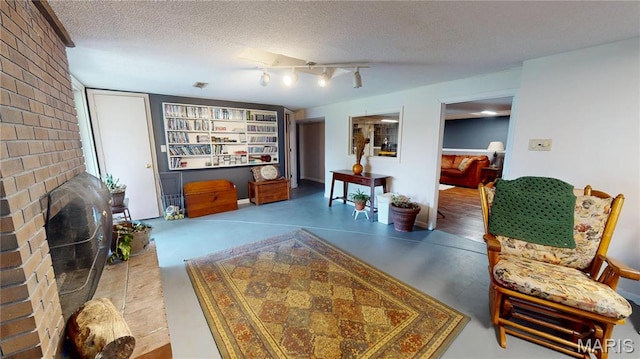 705 Linder Blvd, Greenville, IL 62246 - living room featuring a textured ceiling and a fireplace