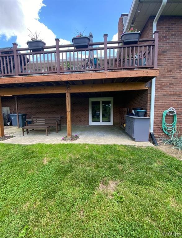 705 Linder Blvd, Greenville, IL 62246 - rear view of house featuring a patio area, brick siding, and a yard