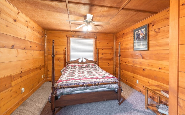 bedroom featuring carpet flooring, wood ceiling, wooden walls, and ceiling fan