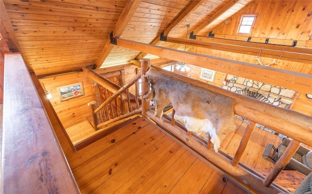stairway with wood ceiling, wooden walls, and wood-type flooring