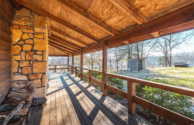 wooden terrace with a shed and an outbuilding