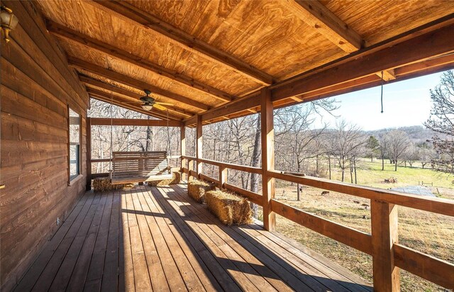 wooden terrace with a ceiling fan
