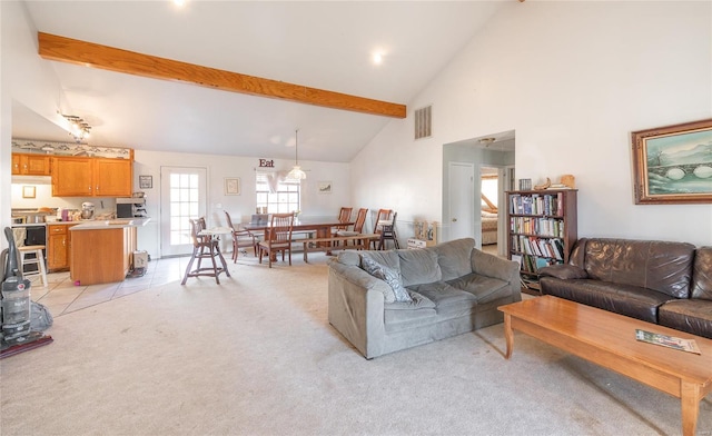 living room with light colored carpet, high vaulted ceiling, and beamed ceiling
