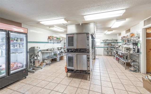 kitchen with light tile patterned floors and a textured ceiling
