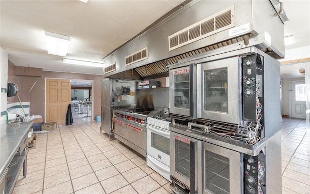 kitchen featuring light tile patterned floors and gas range gas stove