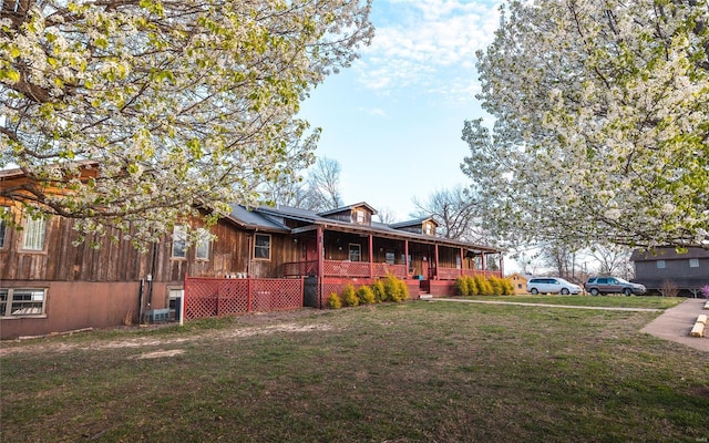 view of front of house with a porch and a front lawn
