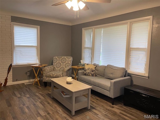 living area featuring a ceiling fan, dark wood-style flooring, plenty of natural light, and baseboards