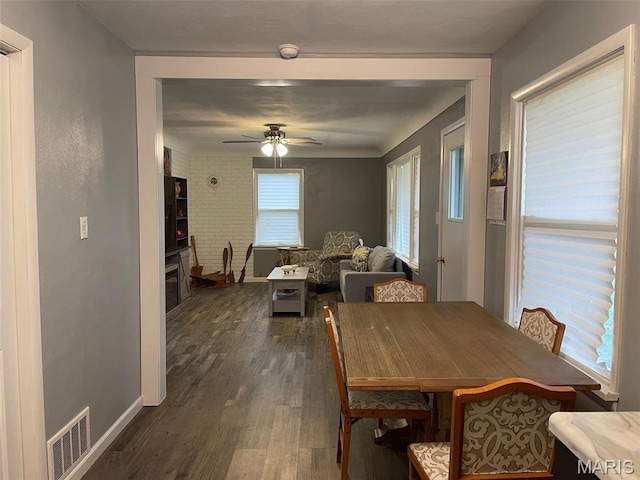 dining area with dark wood-style flooring, a ceiling fan, and baseboards