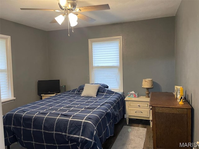 bedroom featuring dark wood finished floors and a ceiling fan