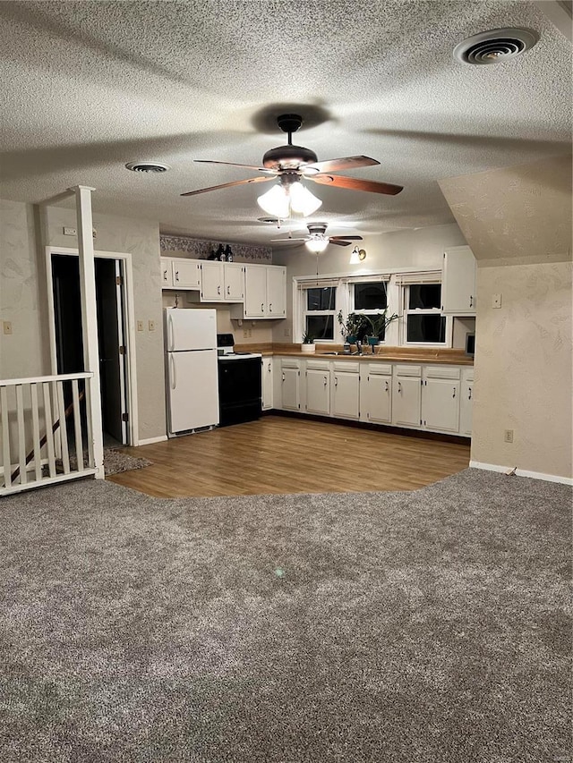 108 Rau St, Waterloo, IL 62298 - kitchen featuring freestanding refrigerator, range with electric stovetop, carpet floors, white cabinets, and a ceiling fan