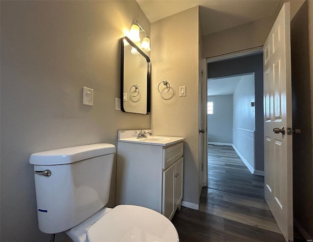 4232 Jennings Station Rd, Saint Louis, MO 63121 - half bath featuring wood finished floors, baseboards, toilet, and vanity