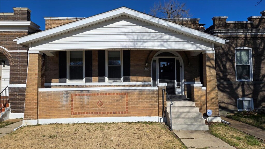 5211 Vermont Ave, Saint Louis, MO 63111 - bungalow-style house featuring brick siding and a porch