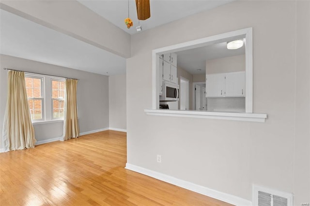 248 S Barat Ave, Ferguson, MO 63135 - empty room featuring light wood-style flooring, baseboards, and ceiling fan