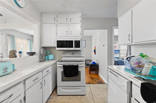 248 S Barat Ave, Ferguson, MO 63135 - kitchen featuring white appliances, light countertops, and white cabinetry