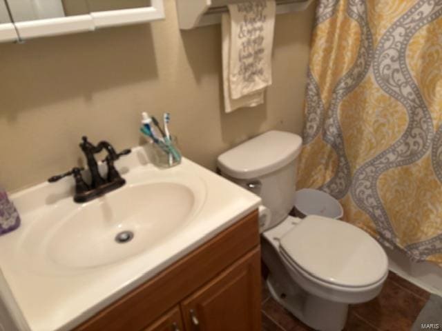 bathroom featuring vanity, toilet, and tile patterned flooring