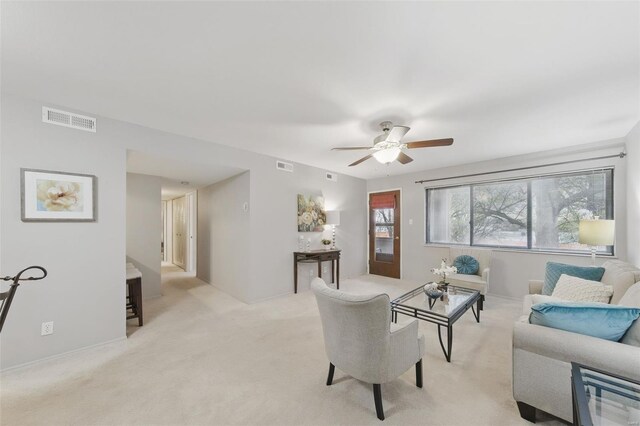 living area featuring a ceiling fan and light carpet