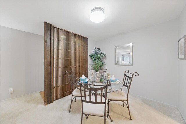 dining room featuring light colored carpet