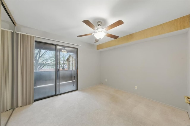carpeted spare room with ceiling fan