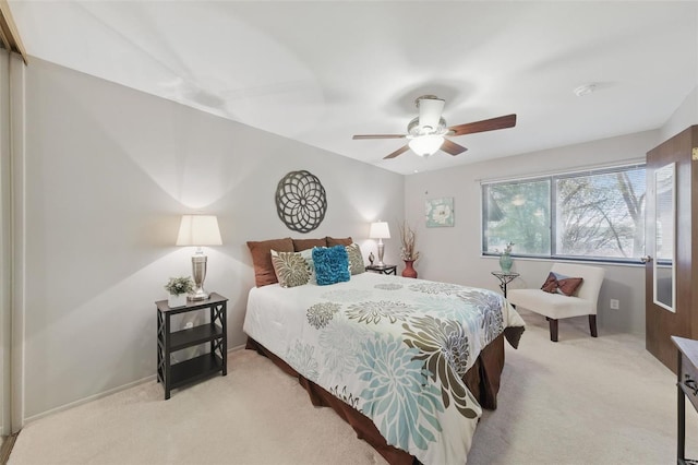 bedroom with light colored carpet and ceiling fan