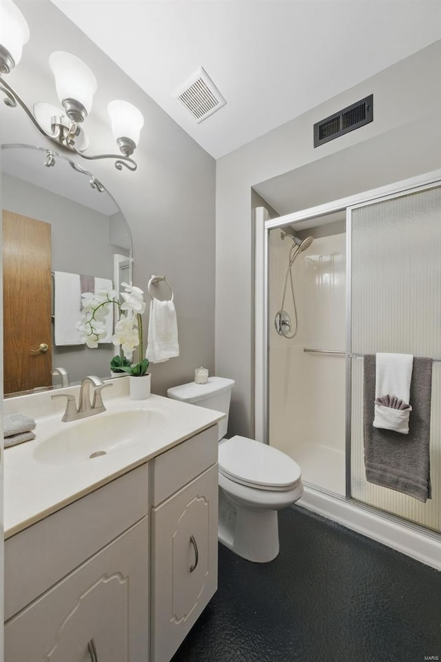 bathroom featuring a stall shower, toilet, and vanity