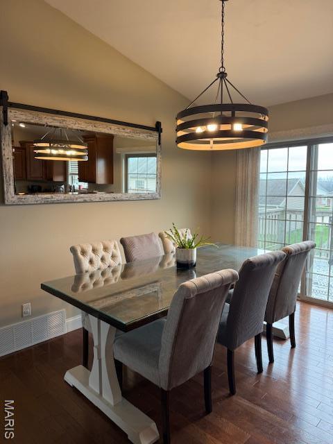 1607 Enterprise Ct, Jackson, MO 63755 - dining area with healthy amount of natural light, vaulted ceiling, a chandelier, and dark wood-type flooring