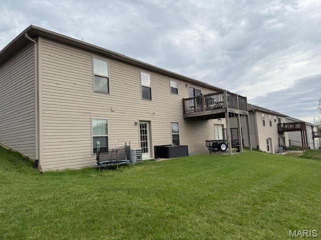 1607 Enterprise Ct, Jackson, MO 63755 - rear view of house featuring a lawn
