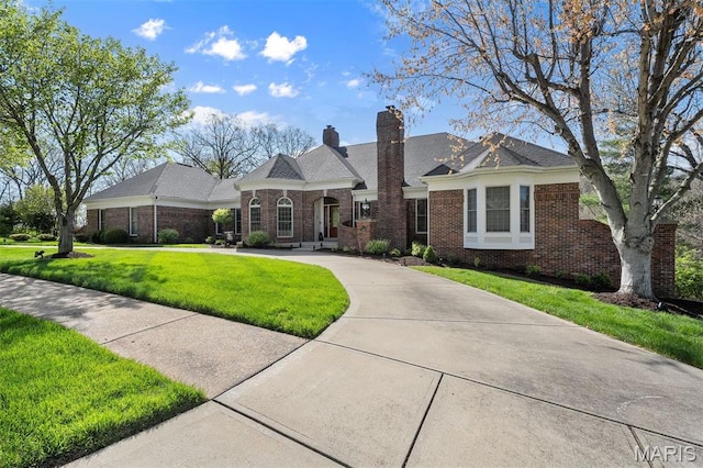 1416 Haarman Oak Dr, Wildwood, MO 63005 - french country style house with a front lawn, brick siding, driveway, and a chimney