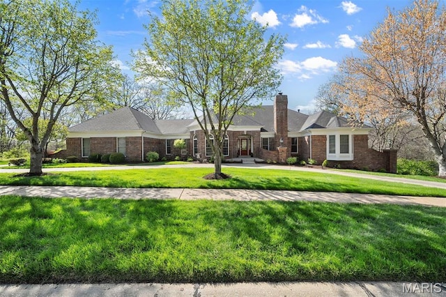 1416 Haarman Oak Dr, Wildwood, MO 63005 - view of front of house with a front yard, brick siding, and a chimney