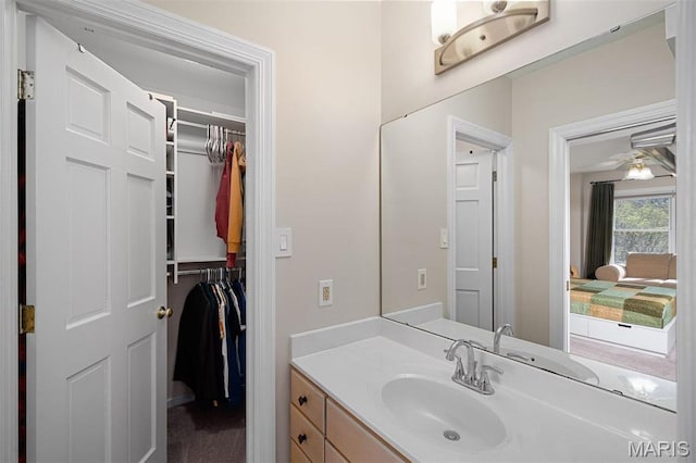 1416 Haarman Oak Dr, Wildwood, MO 63005 - bathroom with vanity, a walk in closet, and ceiling fan