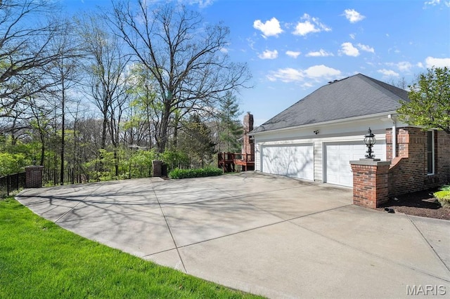 1416 Haarman Oak Dr, Wildwood, MO 63005 - view of property exterior featuring a garage, driveway, and a chimney