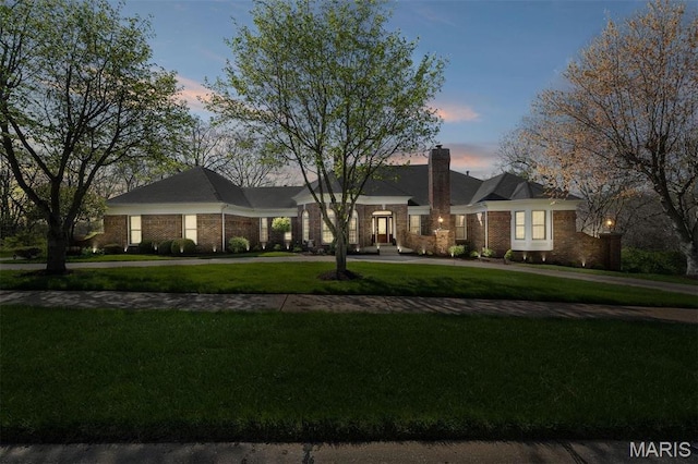 1416 Haarman Oak Dr, Wildwood, MO 63005 - view of front facade featuring curved driveway, a yard, brick siding, and a chimney