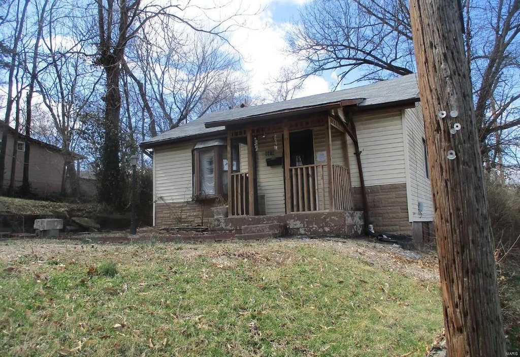 5475 Janet Ave, Saint Louis, MO 63136 - view of front of property featuring a porch and roof with shingles
