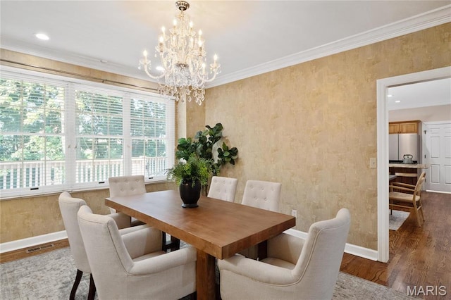 dining room featuring baseboards, wood finished floors, a chandelier, ornamental molding, and recessed lighting