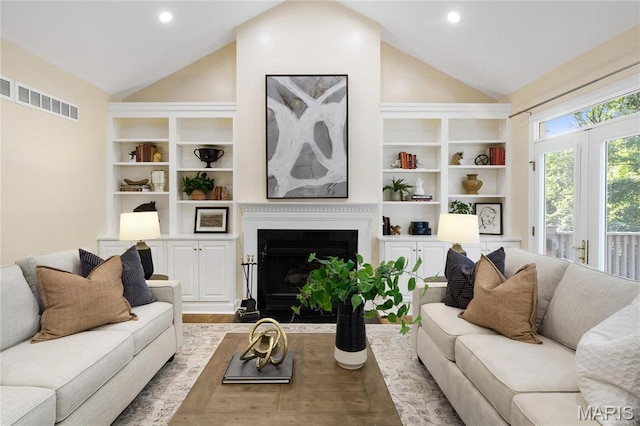 living room with vaulted ceiling, a fireplace with flush hearth, wood finished floors, and recessed lighting
