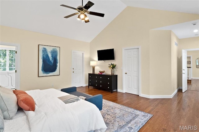 bedroom featuring high vaulted ceiling, wood finished floors, baseboards, and a ceiling fan
