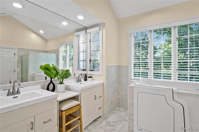 bathroom featuring vaulted ceiling, a stall shower, marble finish flooring, tile walls, and recessed lighting