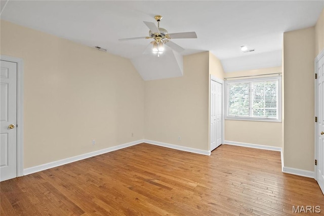 additional living space featuring ceiling fan, light wood-type flooring, baseboards, and lofted ceiling