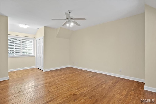 bonus room featuring vaulted ceiling, light wood-type flooring, baseboards, and a ceiling fan