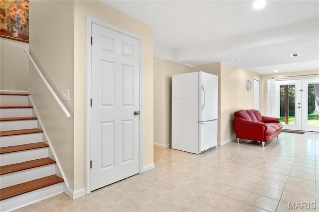 living area with light tile patterned flooring, baseboards, stairs, french doors, and recessed lighting