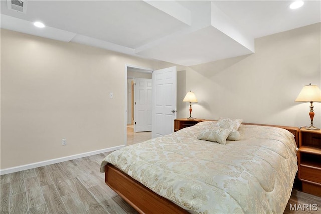 bedroom featuring light wood-type flooring, recessed lighting, and baseboards