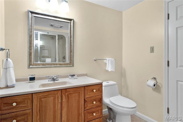 full bath with toilet, vanity, and baseboards