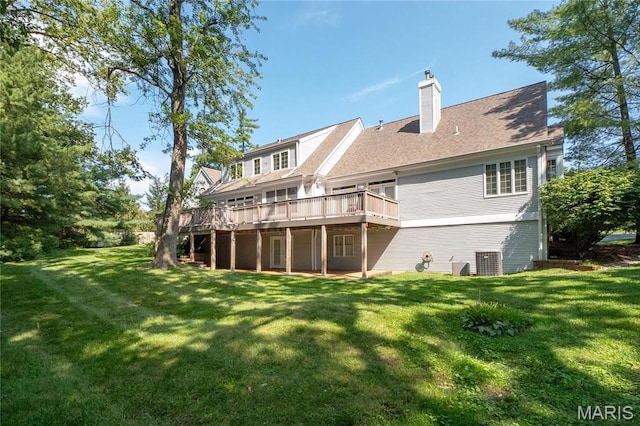 back of house featuring a wooden deck, a lawn, and a chimney