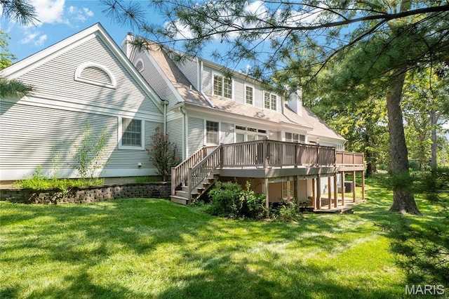 back of house with a deck, a yard, stairway, and a chimney