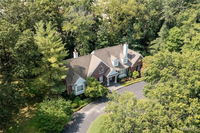 view of subject property with a heavily wooded area