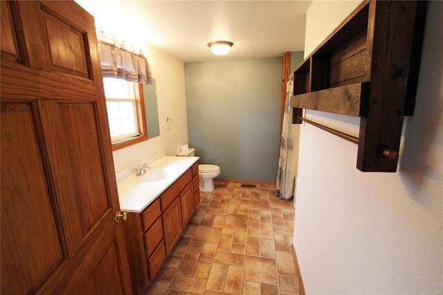 634 Ccam Rose Ln, Perryville, MO 63775 - full bath featuring toilet, vanity, brick patterned floors, and baseboards
